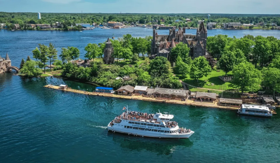 Sightseeing boat gliding past Singer Castle and granite islets on a Gananoque area 1000 Islands boat tour from Ivy Lea, Ontario